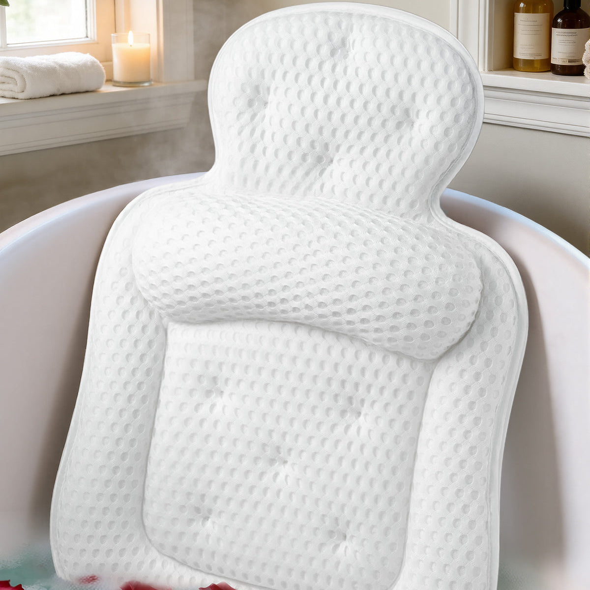 White bath pillow in a bathtub with water and petals Main image